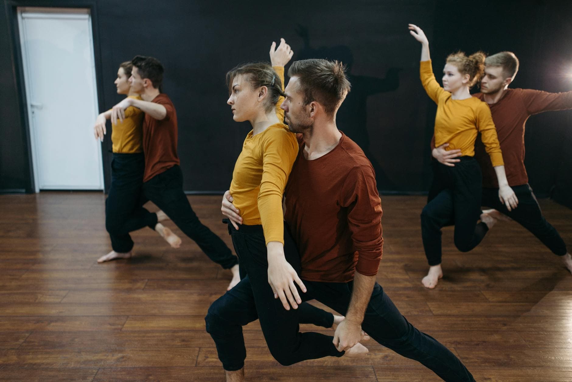 Dancers performing in a bright dance studio